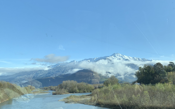 Driving over the River Isere with the Alps in the distance.