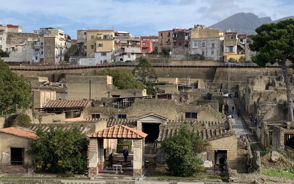Herculaneum in the foreground with the current town of Ercolano above it and Vesuvius in the background.