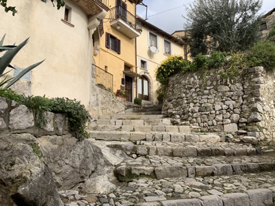 Steps up into the town.