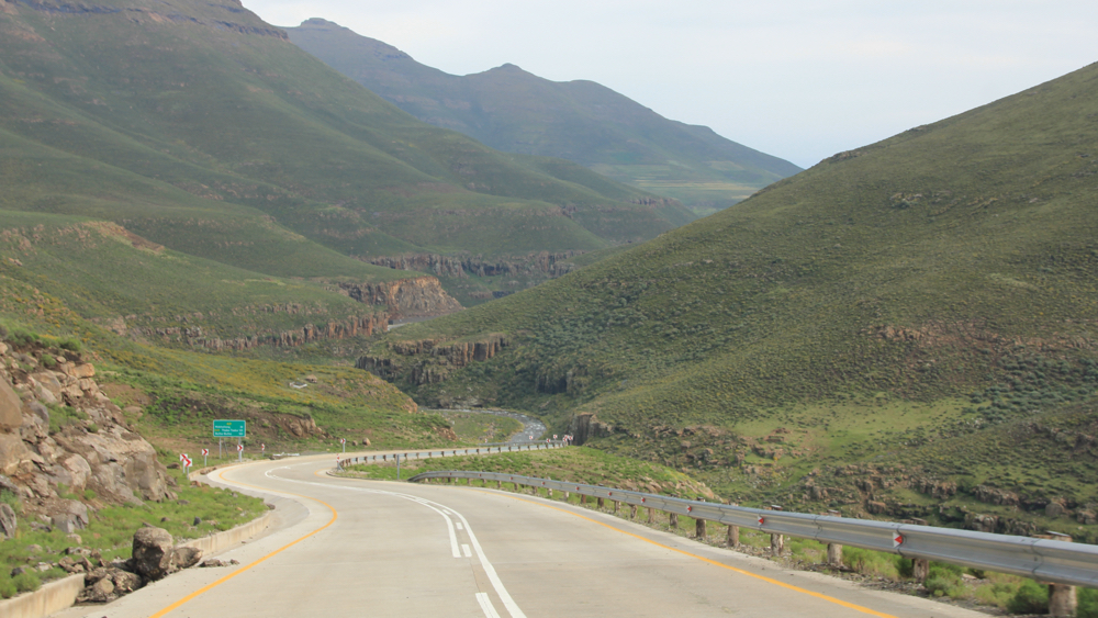 Yhe tar road winding through the mountains.