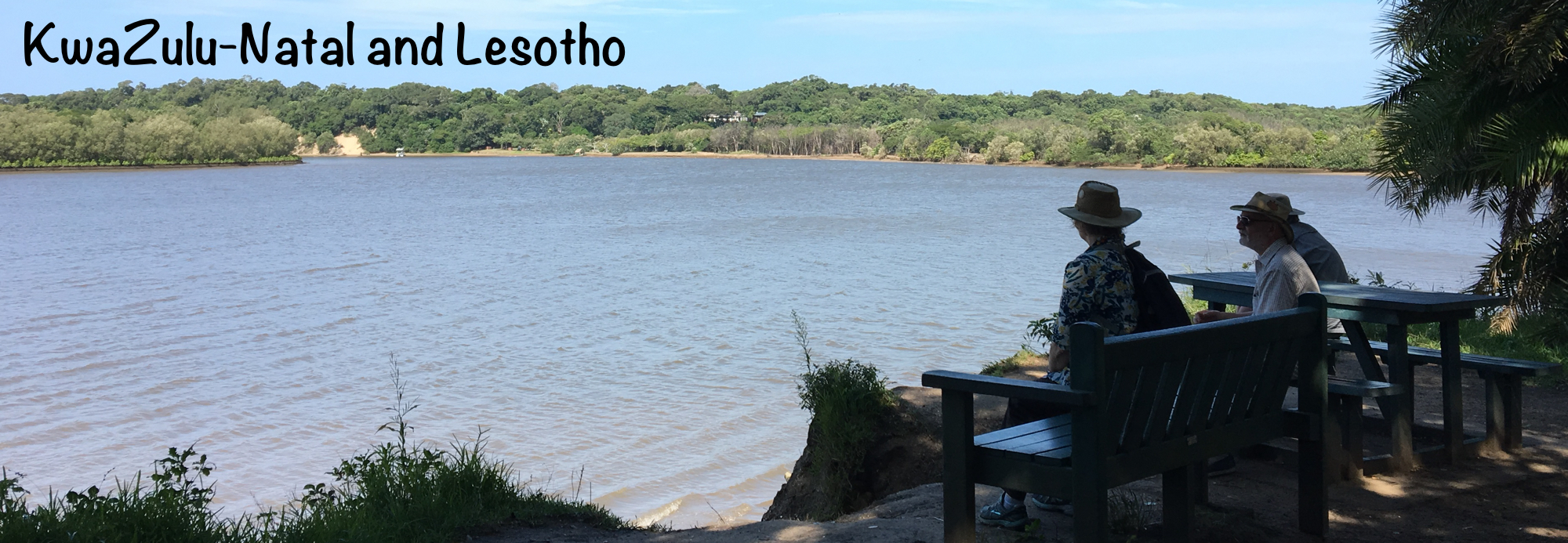 Kevin, Diana and David sitting at a picnic bench overlooking the Umlalazi lagoon.
