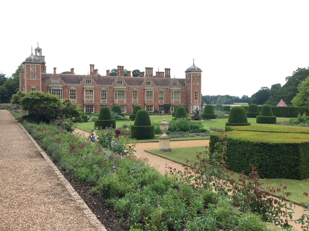 Formal gardens with the house in the background.