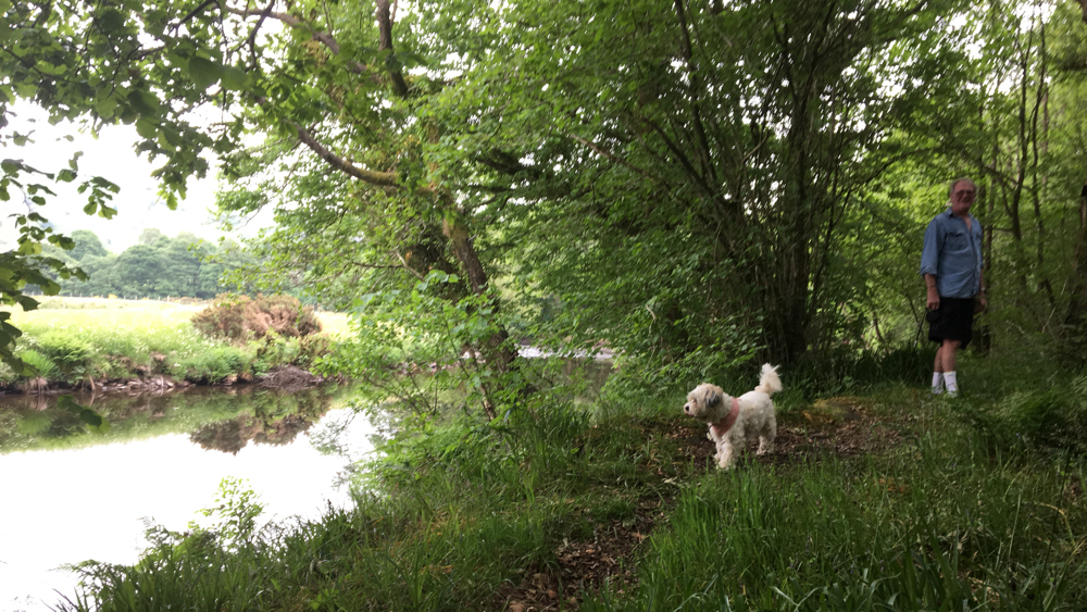 Kevin adn Gracie walking along a path net to the river.