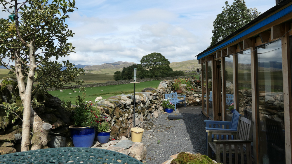 The view from the terrace - fields with sheep and distant mountains..