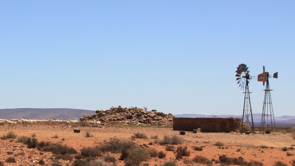 A new solar pump next to an old wind pump.