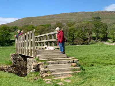 Jella and Gracie (her dog) on a footbridge
