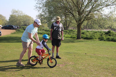  James helping Bertie to get going on his bike