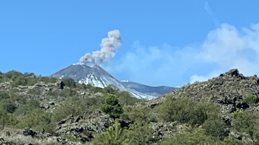Mount Etna with steam and ash.