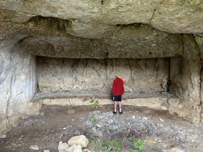 A long carved stone bench in a cave