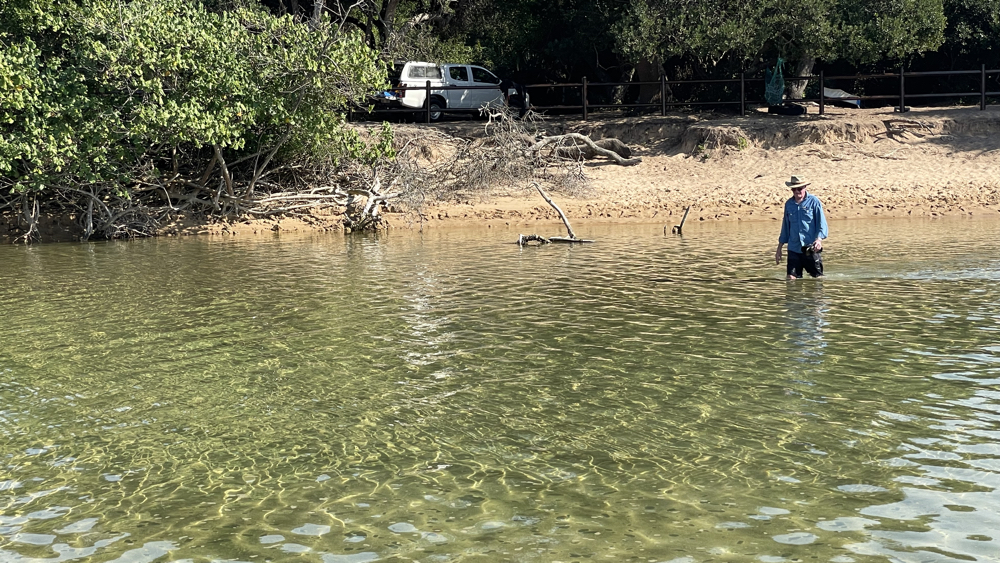 Kevin wading across the lagoon.