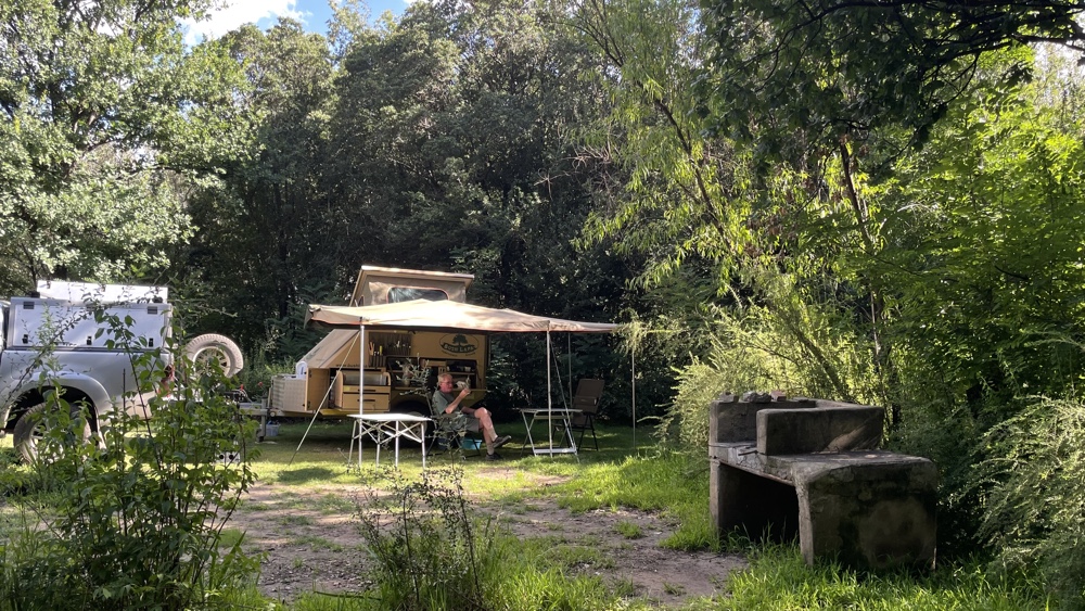 Our campsite amongst trees and long grass.